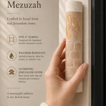 Cream Jerusalem stone mezuzah with a gold shin mounted on a doorpost as Jewish home decor.