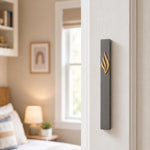 Vertical mounted Slim charcoal gray mezuzah case with gold three-part eternal flame and stylized Shin on right doorpost