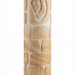 Decorative round Jerusalem stone Mezuzah engraved with Kotel image, showcasing smooth and rough textures, in bright studio setting with soft reflection.