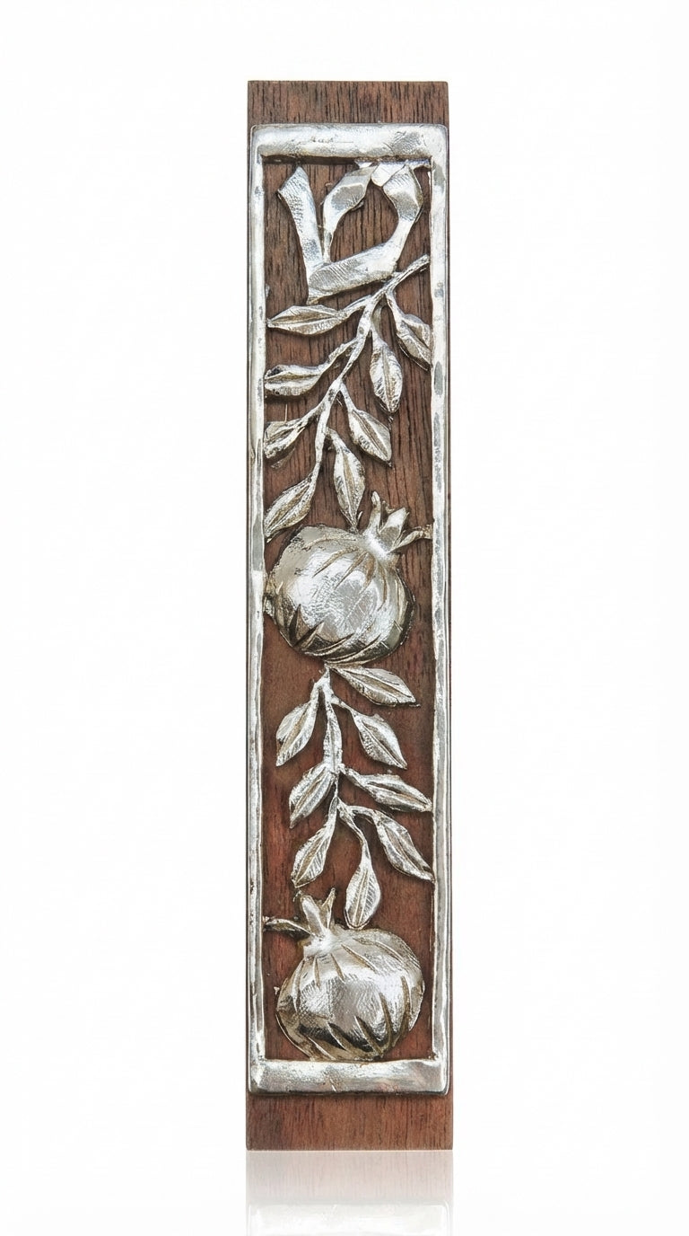 Handcrafted mahogany and pewter mezuzah with pomegranate design, perfect for Jewish home doorways, shown on a white studio background with subtle reflection.