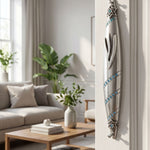 Hyper-realistic scene showing sapphire trail pewter mezuzah on the right side inside a stylish home doorway with warm lighting and elegant decor.