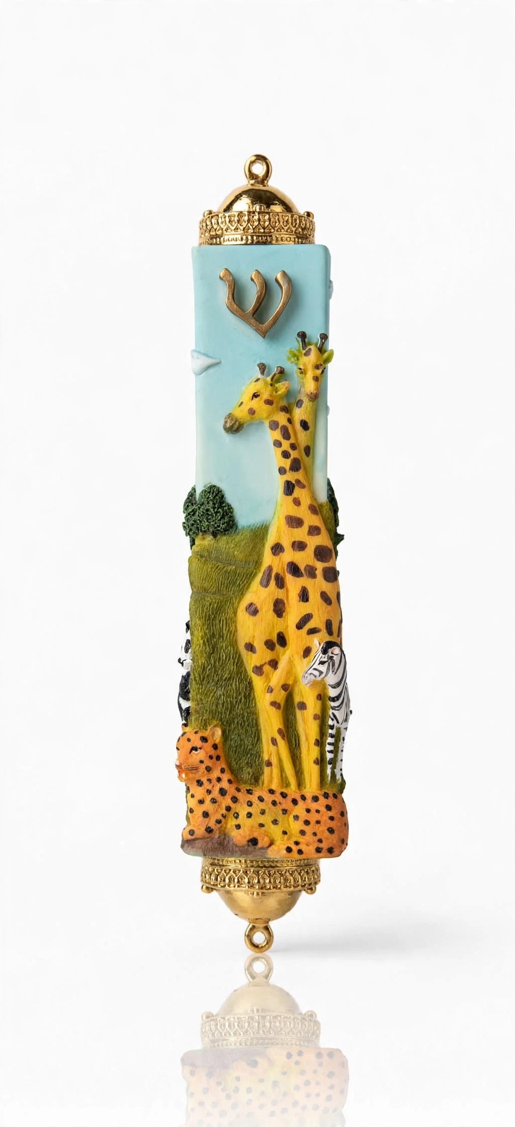 Alternate front view of the Savannah Safari Fimo Mezuzah mezuzah cover, showing a pale blue Fimo body with tall yellow giraffes, a zebra, spotted animals, green scenery and a gold-colored Hebrew Shin beneath decorative brass fittings and the full decorative shape in a closer product photograph of this distinctive Jewish doorway design