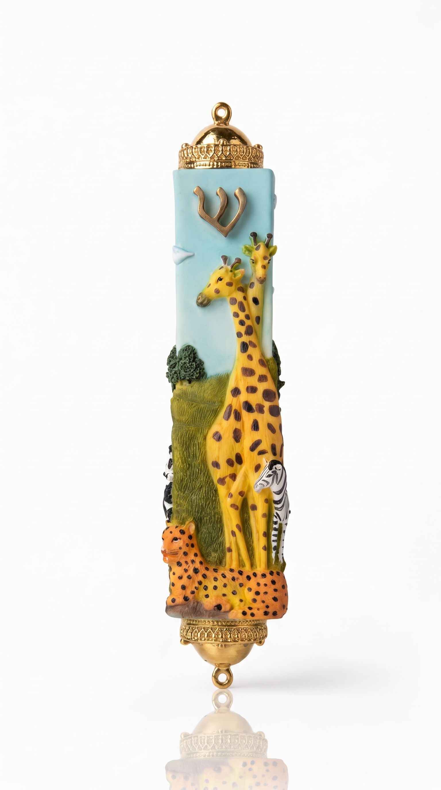 Savannah Safari Fimo Mezuzah shown from the front as a mezuzah cover featuring a pale blue Fimo body with tall yellow giraffes, a zebra, spotted animals, green scenery and a gold-colored Hebrew Shin beneath decorative brass fittings, presenting a detailed Judaica design for a Jewish home doorway