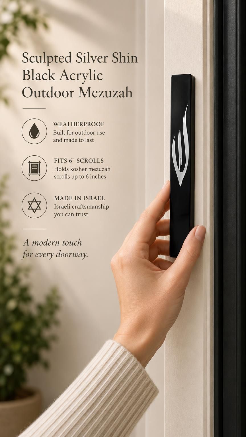 A person holding a sleek black acrylic mezuzah case featuring a prominent silver Shin letter designed for outdoor entryways