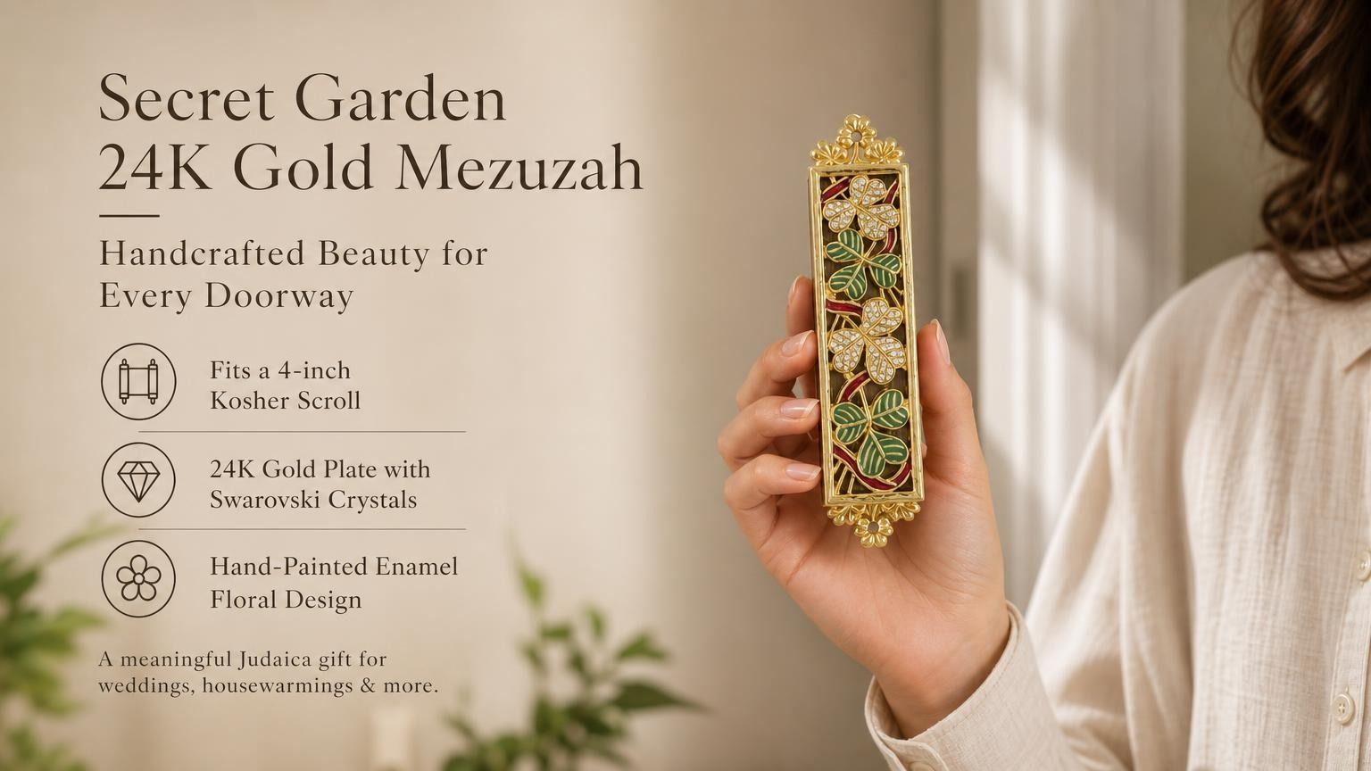 Secret Garden 24K gold-plated mezuzah case held in a woman’s hand, featuring colorful hand-painted floral enamel, green leaves, jeweled flowers, Swarovski crystals, and ornate gold detailing. This elegant Jewish Judaica mezuzah case fits a 4-inch kosher mezuzah scroll and makes a meaningful wedding, housewarming, or new home gift
