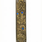 Elegant secret garden themed mezuzah made of pewter and brass, measuring 5 inches tall, with detailed Hebrew engravings and decorative motifs.