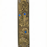 Elegant secret garden themed mezuzah made of pewter and brass, measuring 5 inches tall, with detailed Hebrew engravings and decorative motifs.