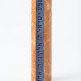 Shema Mezuzah crafted from Jerusalem stone with inlaid glass strip bearing Hebrew prayer, mounted on a white studio background with subtle reflection.