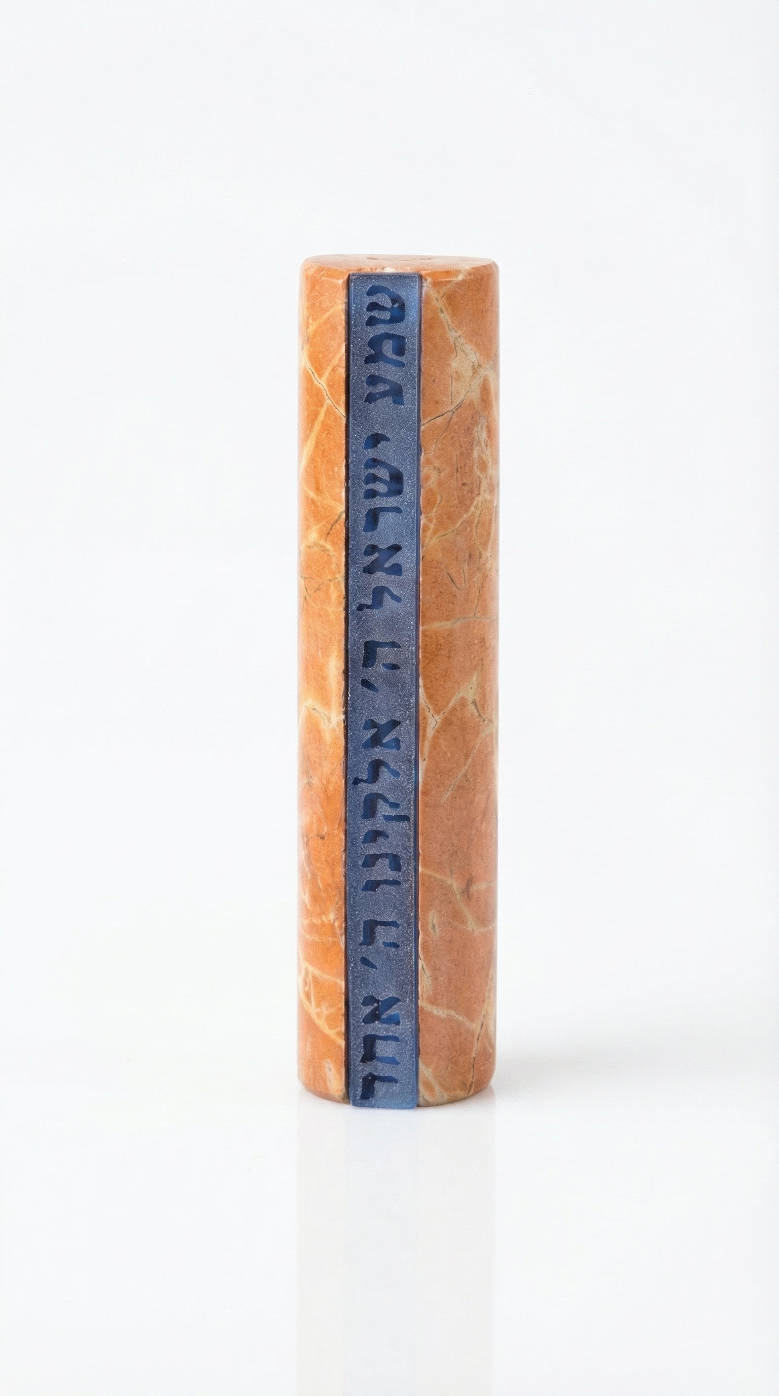 Shema Mezuzah crafted from Jerusalem stone with inlaid glass strip bearing Hebrew prayer, mounted on a white studio background with subtle reflection.