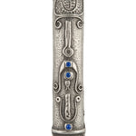 Elegant Shin Mezuzah with blue accents and intricate Middle Eastern motifs, mounted on a clean white background with soft reflection.
