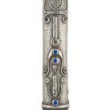 Elegant Shin Mezuzah with blue accents and intricate Middle Eastern motifs, mounted on a clean white background with soft reflection.