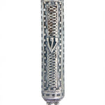 Sterling silver filigree accordion mezuzah with intricate design and Hebrew engravings, displayed on a white studio surface with soft reflection.