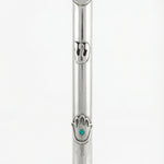 Sterling silver Mezuzah with Hamsa design and turquoise detail, on a white studio background with a soft reflection.