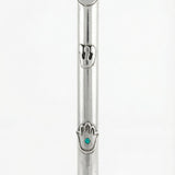 Sterling silver Mezuzah with Hamsa design and turquoise detail, on a white studio background with a soft reflection.