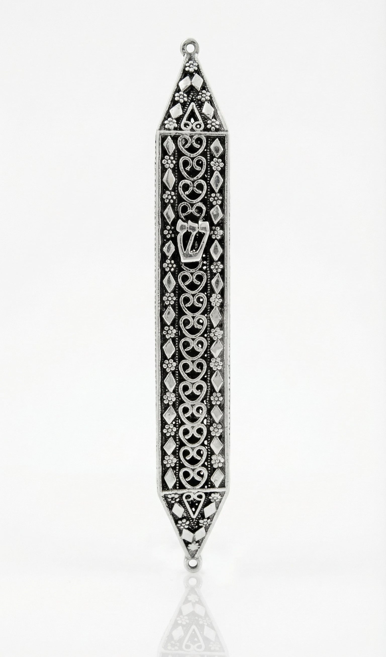 Handmade sterling silver mezuzah with floral motifs and diamond accents, crafted with traditional Italian silversmith techniques for a textured, detailed appearance.