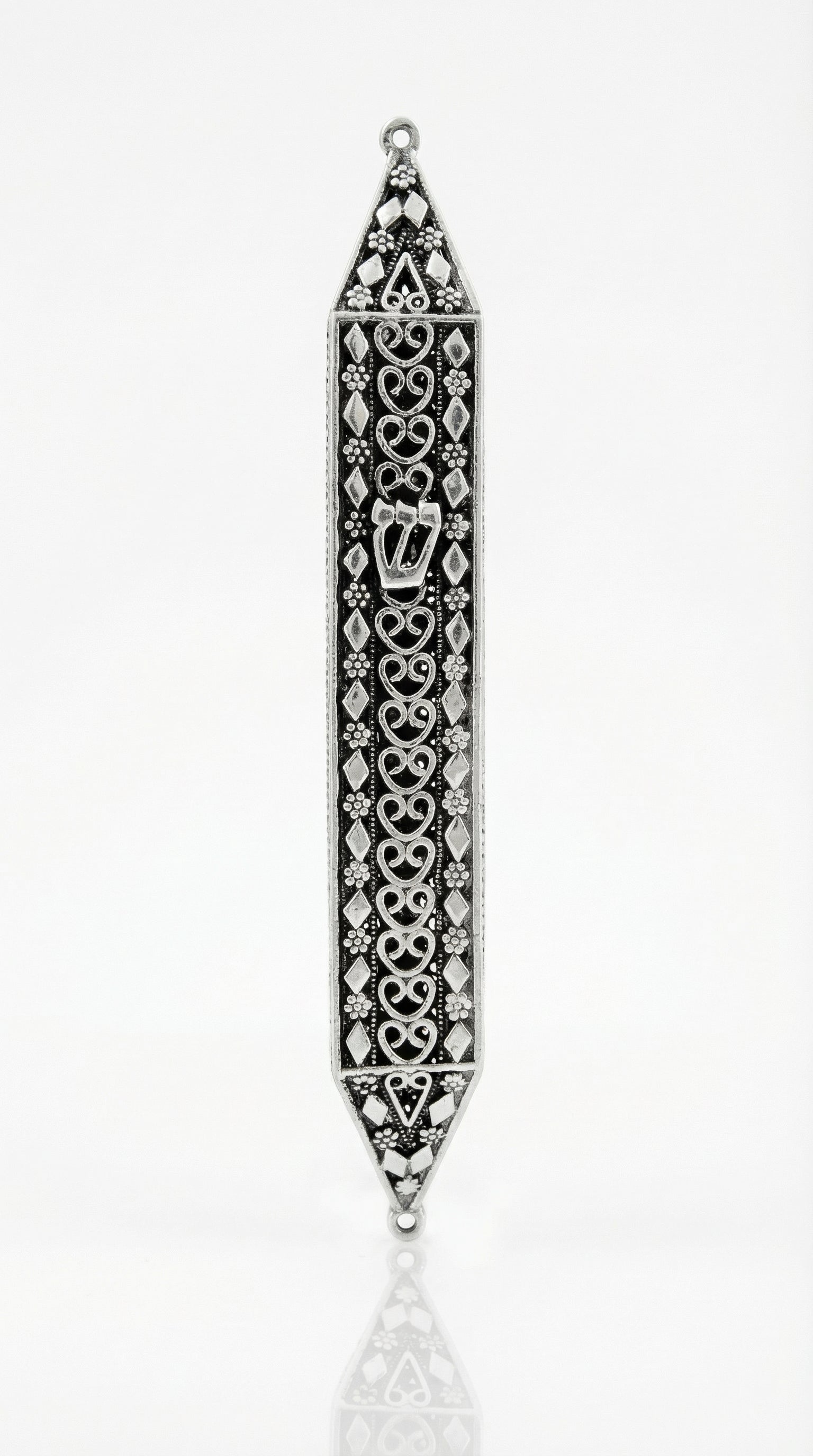 Handmade sterling silver mezuzah with floral motifs and diamond accents, crafted with traditional Italian silversmith techniques for a textured, detailed appearance.