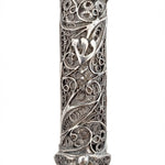 Elegant handmade silver mezuzah with intricate filigree, transparency to view parchment, and traditional Hebrew engravings on a white background.
