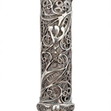 Elegant handmade silver mezuzah with intricate filigree, transparency to view parchment, and traditional Hebrew engravings on a white background.
