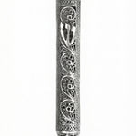Handmade sterling silver mezuzah with paisley pattern, intricate tracery, transparent design showcasing parchment, on a white studio background with light reflection.