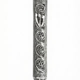 Handmade sterling silver mezuzah with paisley pattern, intricate tracery, transparent design showcasing parchment, on a white studio background with light reflection.