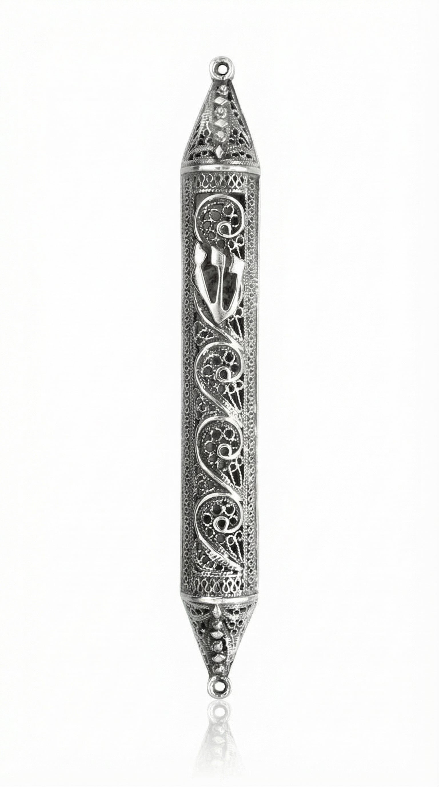 Handmade sterling silver mezuzah with paisley pattern, intricate tracery, transparent design showcasing parchment, on a white studio background with light reflection.