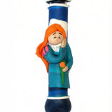 Walking beauty resting peacefully on a sweet Fimo mezuzah, designed for children, with a bright white background and soft reflection.