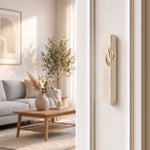 Small Modern Cream Jerusalem Stone Mezuzah mounted on a white interior doorpost, where its warm natural texture, rounded base, and gold Shin give the doorway a distinct Jewish detail