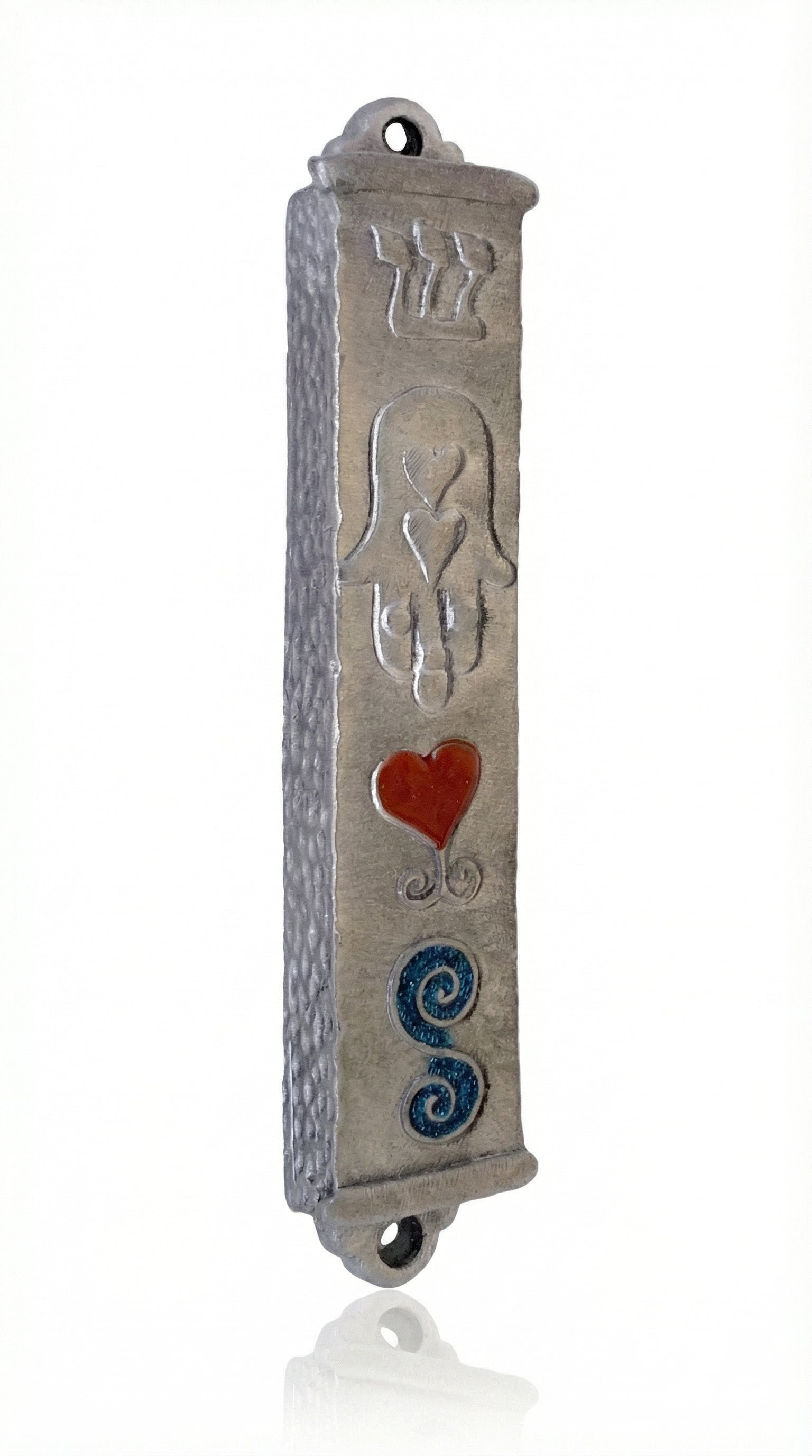 Petite Moroccan style pewter mezuzah with Hebrew engravings and decorative motifs, displayed on a white studio background with subtle reflection.