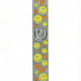 Vibrant yellow and orange smiley face pewter mezuzah, 5 inches tall, with Hebrew initials, decorative motifs, on a white studio background with light reflection.