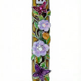 Uplifting pewter mezuzah decorated with dewy violet blossoms, fluttering butterflies, and a hidden ladybug, with a white studio background and soft reflection.