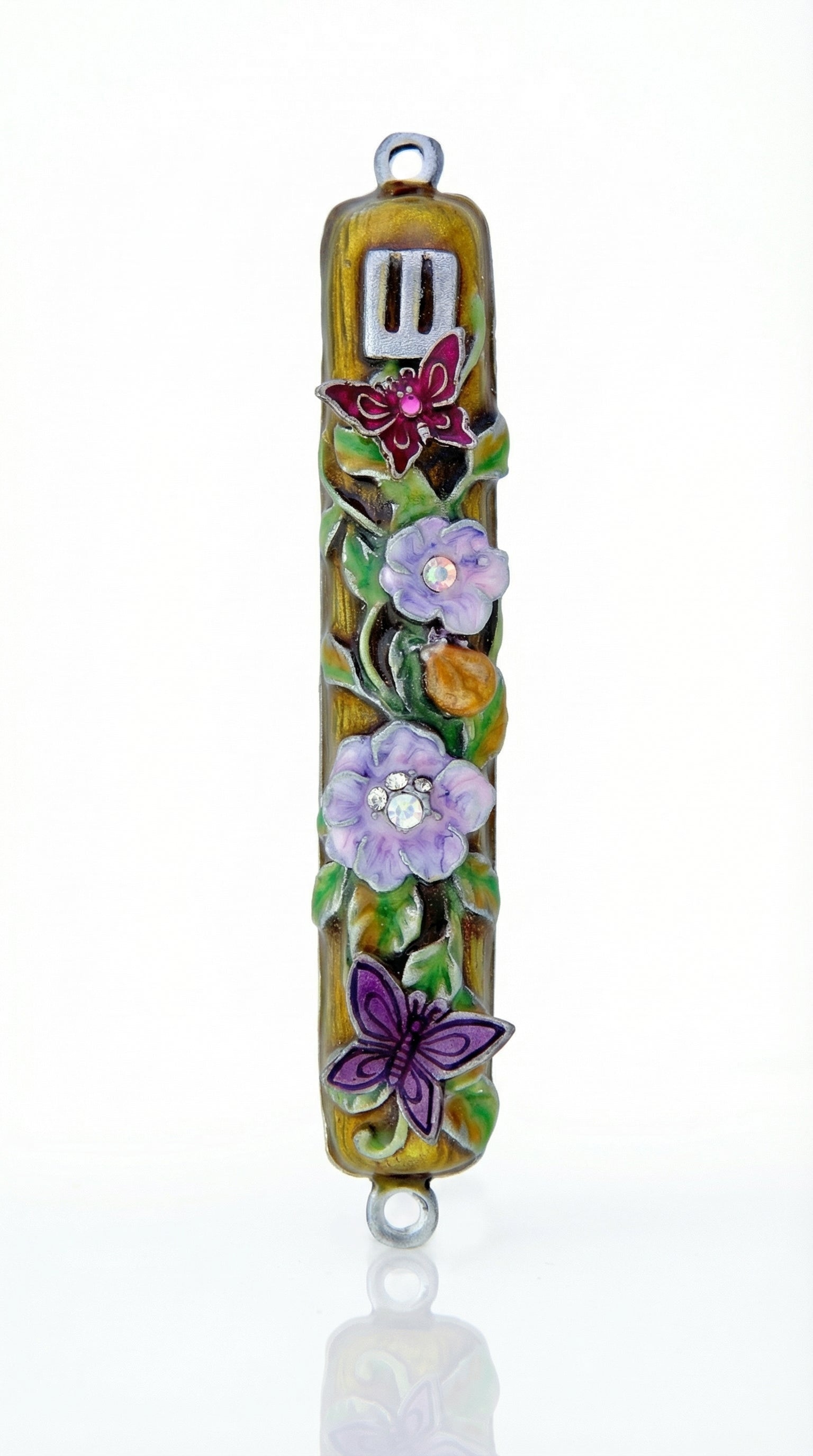 Uplifting pewter mezuzah decorated with dewy violet blossoms, fluttering butterflies, and a hidden ladybug, with a white studio background and soft reflection.