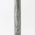 Gray Jerusalem stone mezuzah with engraved Hebrew letters and decorative motifs, displayed on a bright white studio background with soft reflection.