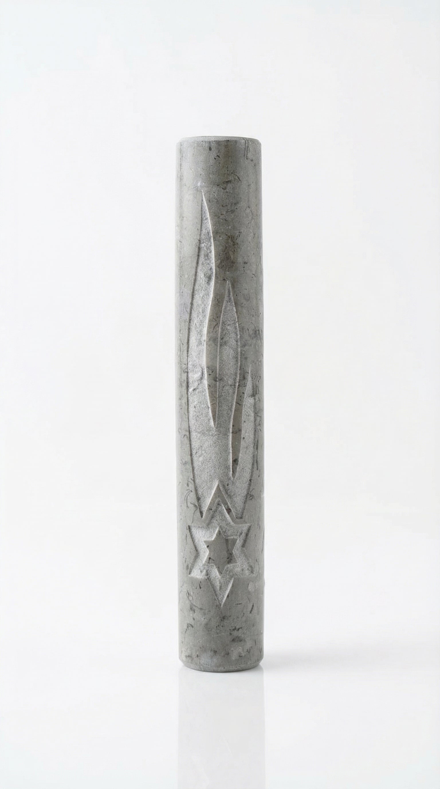 Gray Jerusalem stone mezuzah with engraved Hebrew letters and decorative motifs, displayed on a bright white studio background with soft reflection.