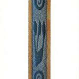 Stone and glass mezuzah with blue frosted glass Shin and swirl design, mounted on a white studio surface with soft reflection.