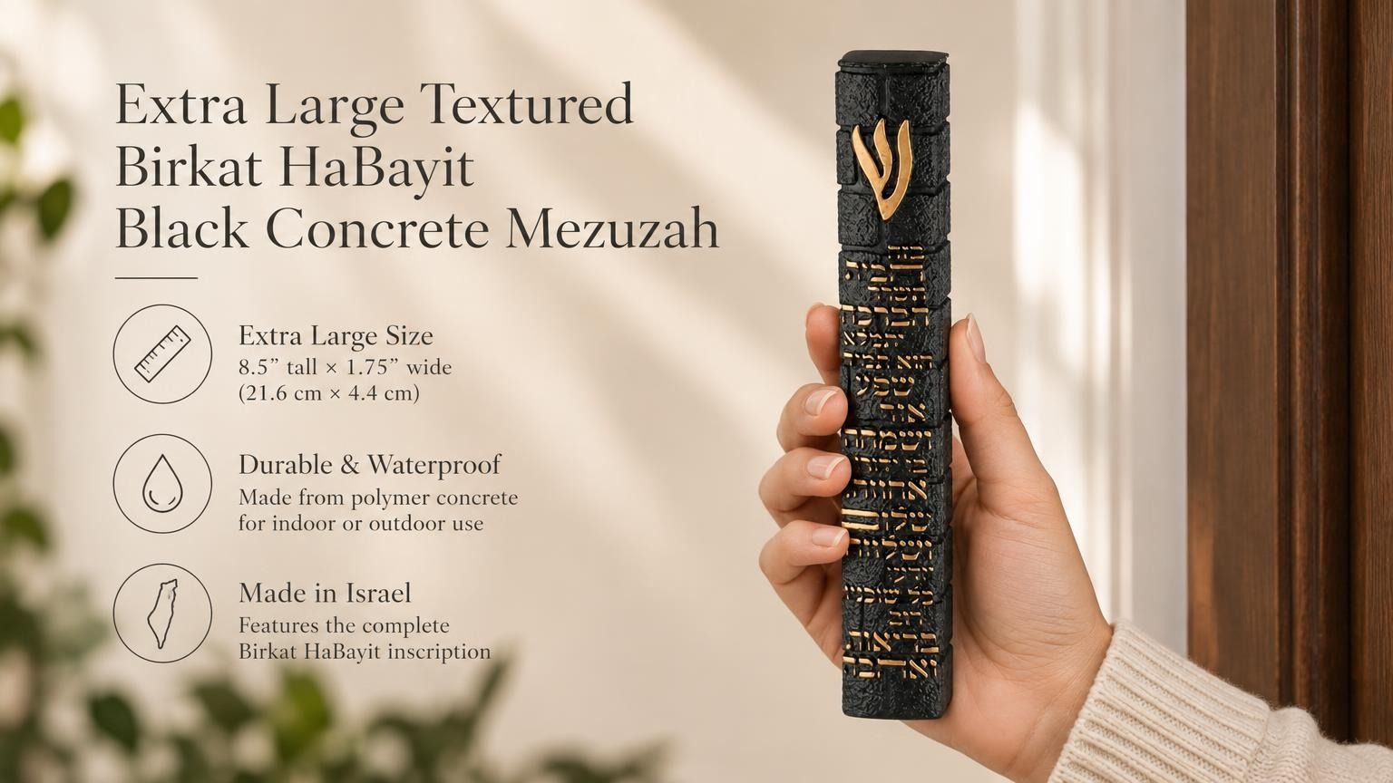 A hand holding a Extra Large Textured Birkat HaBayit Black Concrete Mezuzah made in Israel with gold Hebrew lettering