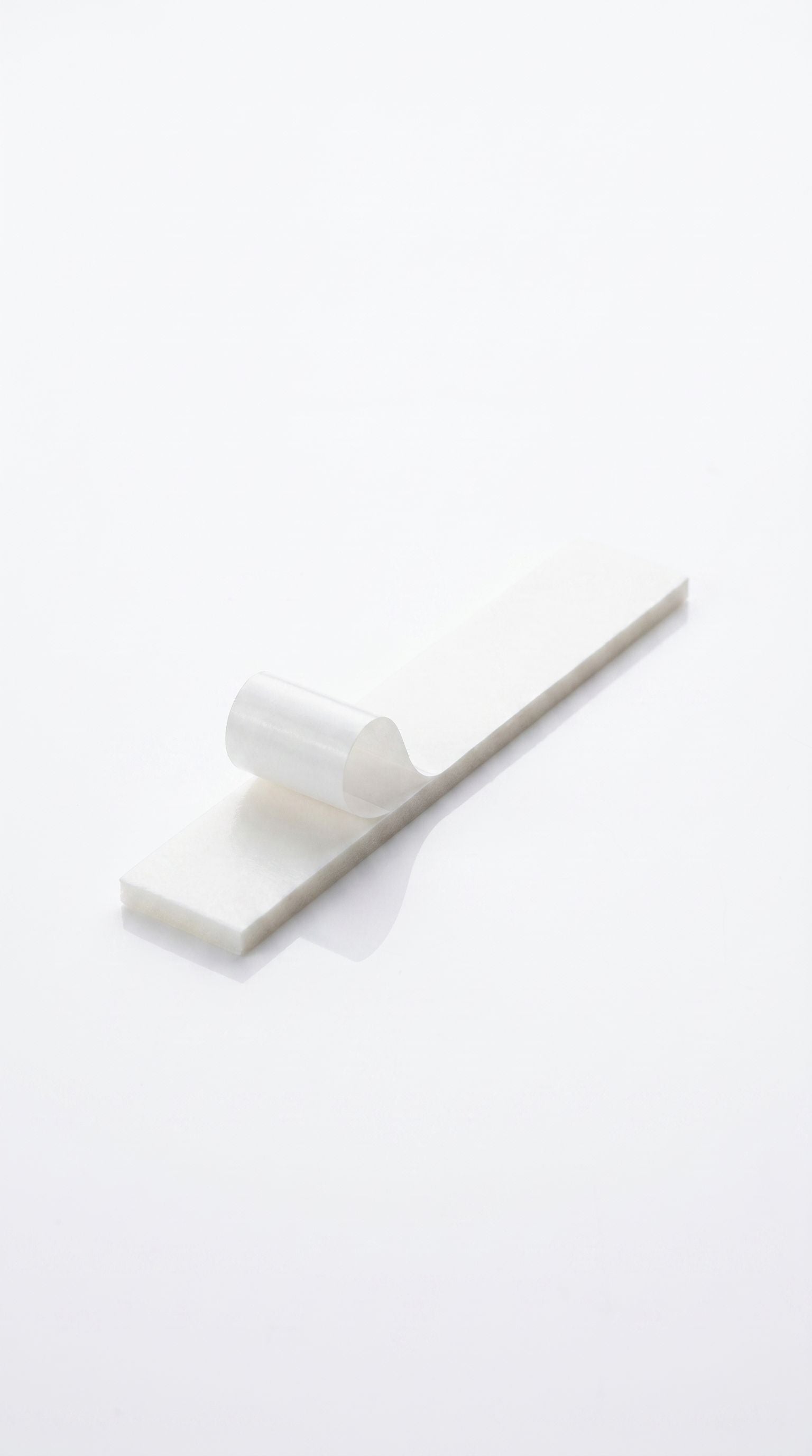 Triple-layered mezzuzah mounting tape for seamless adhesion to smooth surfaces for mezuzah cases.