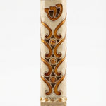 Close-up of a brass Sunrise Mezuzah with detailed Hebrew engravings, shown on a white studio background with a subtle reflection.