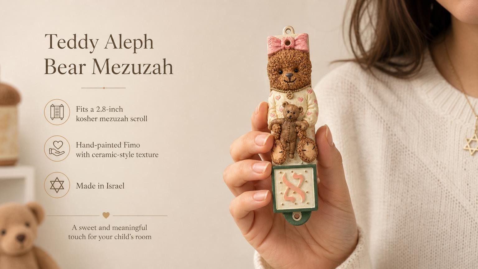 Hand holding Teddy Aleph Bear Mezuzah with soft nursery colors and Hebrew letter Aleph for a child's room decor.