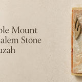 Temple Mount Jerusalem stone mezuzah case mounted vertically beside a doorway, featuring natural cream and warm rust-colored Jerusalem stone with a raised metallic Hebrew Shin. This traditional stone mezuzah brings the look and character of Jerusalem to a Jewish home, entrance, or interior doorway