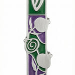 High-resolution image of a pewter pomegranate mezuzah with intricate Hebrew detailing on a white studio background with soft reflection.