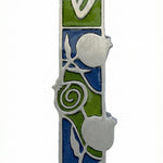 Pewter mezuzah with pomegranate motif, Hebrew script, detailed design, on a white studio background with subtle reflection.