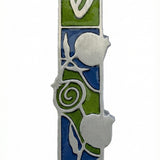 Pewter mezuzah with pomegranate motif, Hebrew script, detailed design, on a white studio background with subtle reflection.