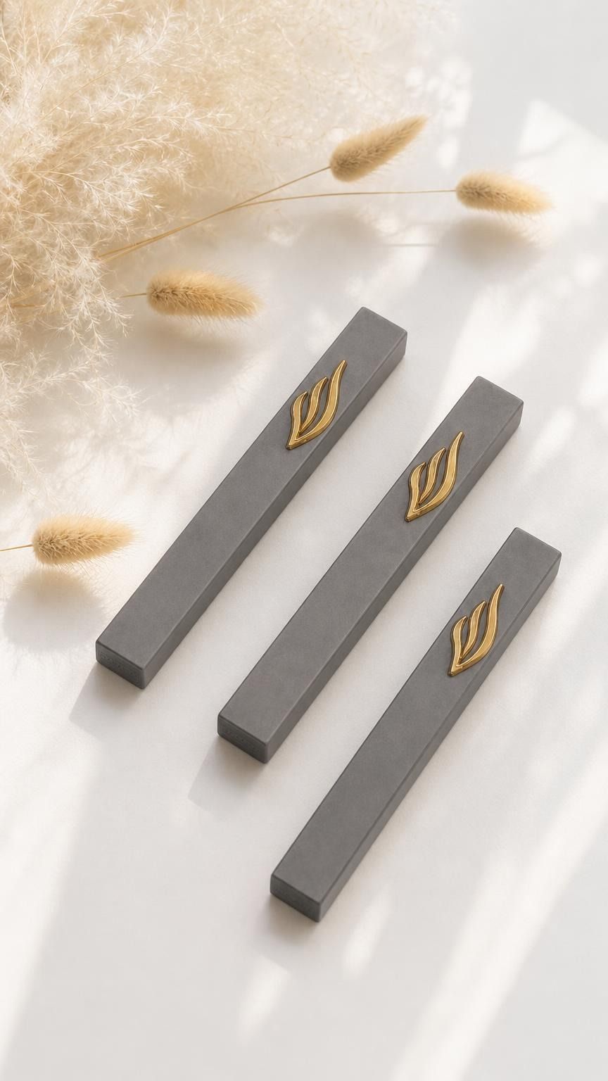 Three minimalist Modern charcoal gray and gold aluminum mezuzah cases