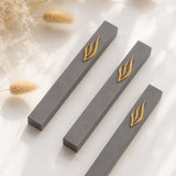 Three minimalist Modern charcoal gray and gold aluminum mezuzah cases