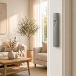 Timeless Raised Silver Shin Gray Cement Mezuzah mounted vertically on a residential doorpost, showing the slim gray cement case and sculptural silver-tone Shin in a bright modern home entrance