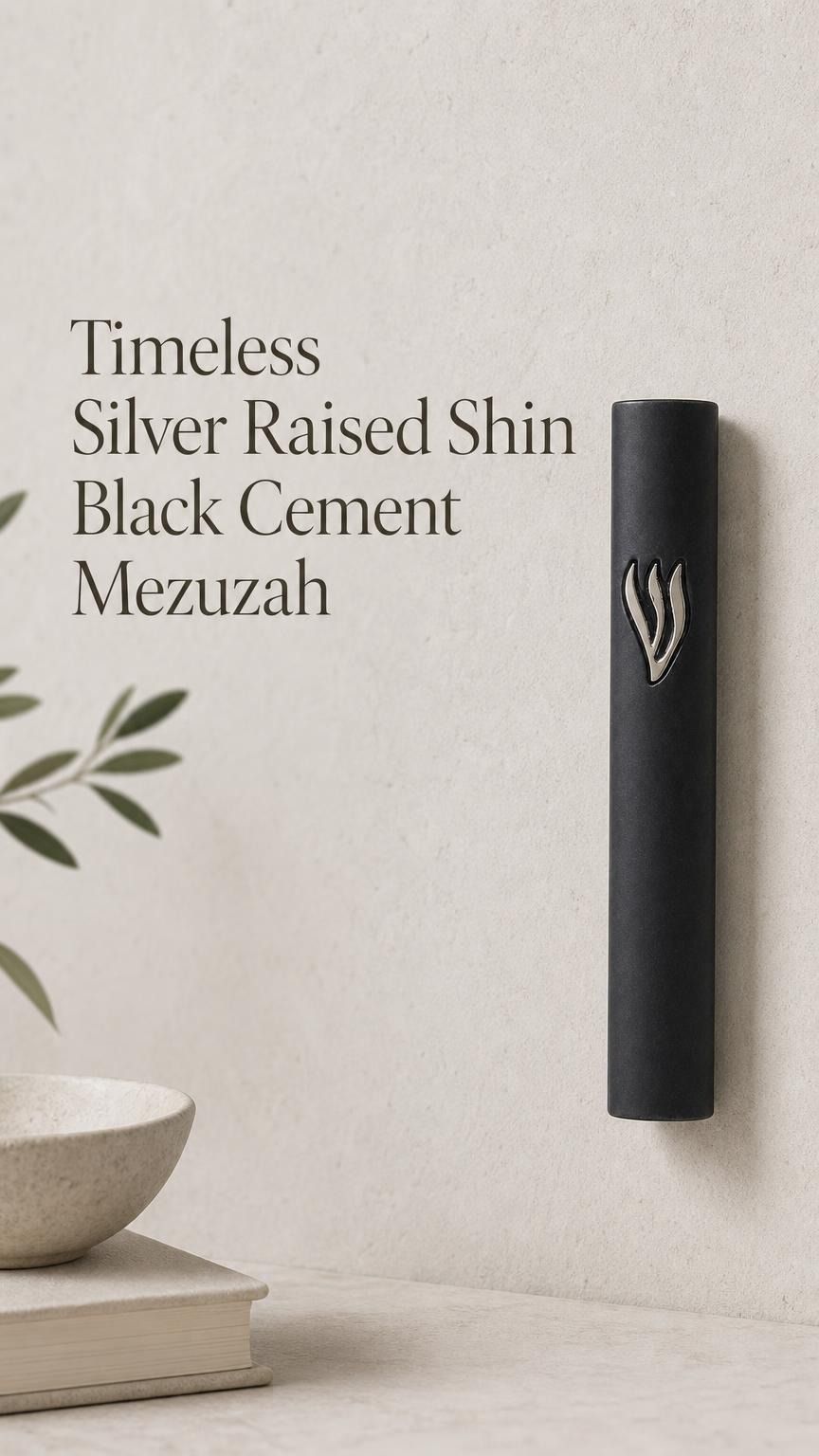 Close product portrait of the Timeless Black Cement Mezuzah featuring a prominent raised silver-tone Shin against the smooth dark surface, emphasizing the sculptural Hebrew letter, monochrome black case, and understated modern design