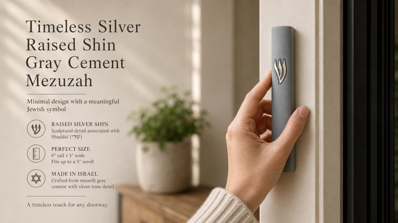 A person holds a 6-inch gray cement mezuzah with a silver Shin letter, showcasing its modern design and architectural scale