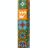 Toscana ceramic mezuzah case standing upright on a white background, its hand-painted orange, green and pale blue Mediterranean tile pattern framing a white Hebrew Shin on an orange panel, sized for a 5-inch kosher mezuzah scroll
