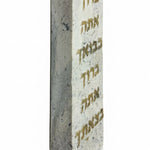 Grey Tiberias stone Mezuzah with Hebrew blessing inscription, 4-inch tall, on white studio background with soft reflection.