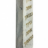 Grey Tiberias stone Mezuzah with Hebrew blessing inscription, 4-inch tall, on white studio background with soft reflection.